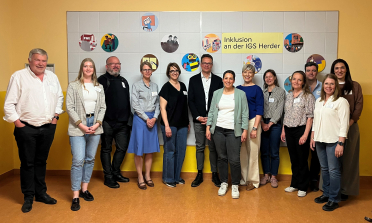 A group of people standing in a school hall