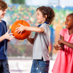 Three children playing with a basketball